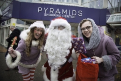 SANTA ARRIVES AT THE PYRAMIDS SHOPPING CENTRE, BIRKENHEAD.... Pictured is Santa with two of his helpers Twinkle (Laurie Coughlin) and Snowdrop (Ollie Thomas).