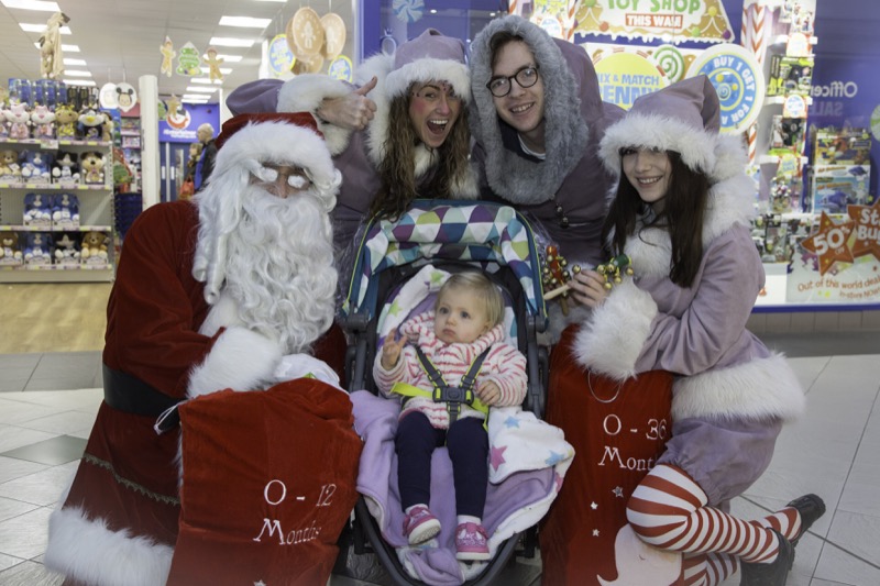 SANTA ARRIVES AT THE PYRAMIDS SHOPPING CENTRE, BIRKENHEAD... Pictured is  Lilly Jones,1 from Morton with Santa, Twinkle (Laurie Coughlin), Snowdrop (Ollie Thomas) and Sparkle (Amy Brumskill).
